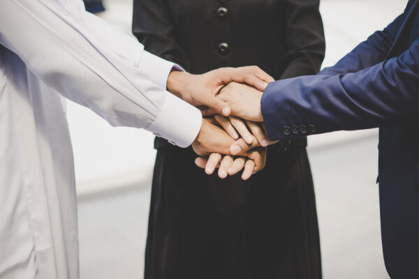 Hands stacks on each other signifying agreement and relationship.