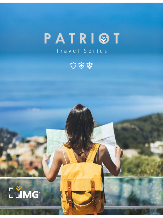 Lady holding travel map looking over the ocean.